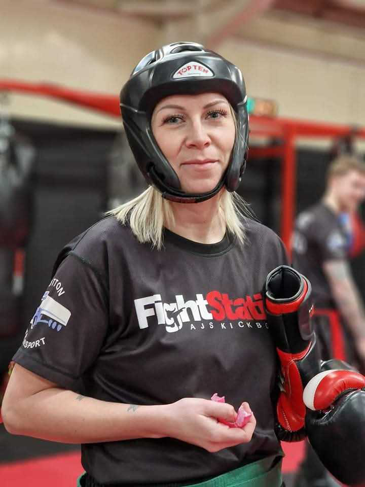 A Fight Club member in headguard and gloves at Fight Station